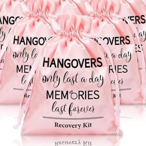 May include: Pink satin drawstring bags with the text "Hangovers only last a day, Memories last forever" in black script. The bags are labeled "Recovery Kit" and are ideal for party favors or gifts.