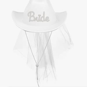 May include: White cowboy hat with the word "Bride" in a pearl-like font. The hat has a matching white veil and a chin strap. This bridal accessory is perfect for a bachelorette party or wedding.