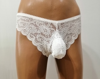 May include: White lace underwear with a delicate floral pattern. The underwear has a pouch in the front.