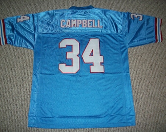 Könnte beinhalten: Ein hellblaues Footballtrikot mit dem Namen "CAMPBELL" und der Nummer "34" auf der Rückseite. Das Trikot hat rote und weiße Einfassungen an den Ärmeln.