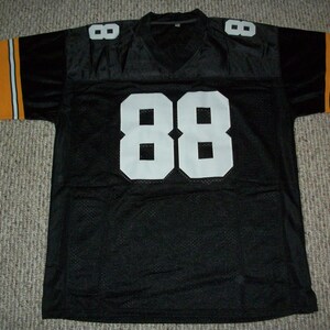 May include: Black football jersey with orange and white stripes on the sleeves and the number 88 in white on the front.