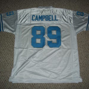 May include: White football jersey with blue trim and the name "CAMPBELL" and number "89" on the back.