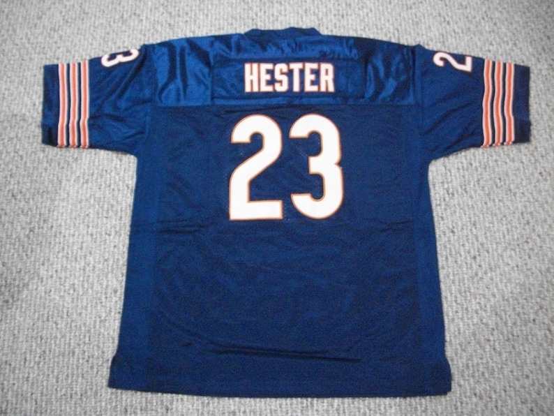 May include: A blue football jersey with the name "HESTER" and the number "23" on the back. The jersey has orange and white stripes on the sleeves.