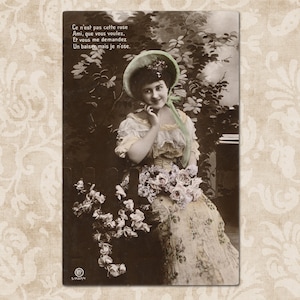 Woman sitting in her garden in a romantic mood - Original vintage French postcard from the early 1900's.