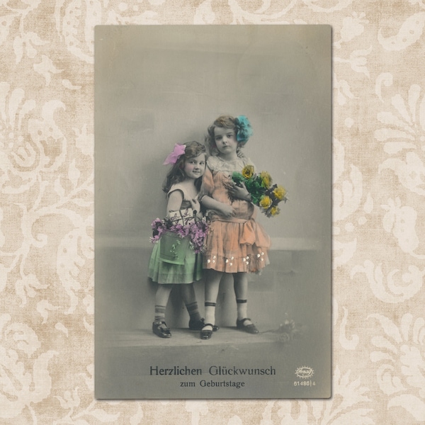 Little girls with flowers and a present - Original vintage German postcard from the early 1900's.