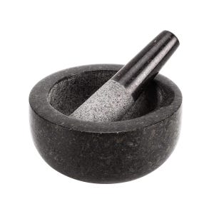 May include: A black granite mortar and pestle set. The mortar is round and has a smooth, polished surface. The pestle is cylindrical and has a rough, textured surface.