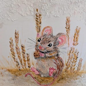 May include: A whimsical painting of a mouse enjoying a cookie amidst wheat stalks. The mouse has brown and gray fur with pink ears and feet. The wheat is golden brown, set against a textured white background, creating a charming, rustic scene.