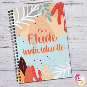 May include: A spiral-bound notebook with a light blue cover featuring abstract leaf illustrations in red, orange, beige, and white. The text Mon Etude individuelle is printed in orange in the center, surrounded by small black dots and foliage.