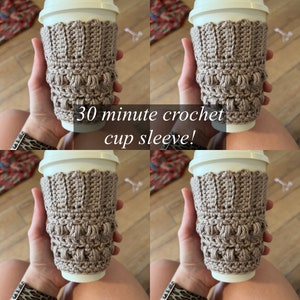 May include: A close-up of four crocheted cup sleeves in a light brown color. The sleeves are made with a textured stitch pattern and have a scalloped top edge. The text "30 minute crochet cup sleeve!" is superimposed on the image.