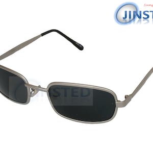May include: Silver-toned rectangular sunglasses with dark gray lenses. The sunglasses have a simple, classic design.