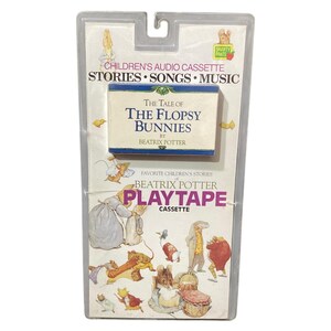 May include: A vintage children's audio cassette featuring "The Tale of The Flopsy Bunnies" by Beatrix Potter. The cassette is in a clear plastic package with the "Playtape" logo and illustrations of the characters.