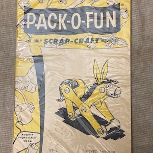 May include: A vintage magazine cover for Pack-O-Fun, The Only Scrap-Craft Magazine. The cover features a yellow and black illustration of a donkey made from craft supplies. The magazine is dated August-September 1956.