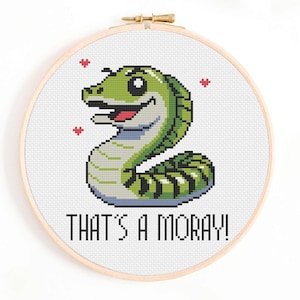 May include: Cross stitch pattern of a green and white moray eel with a smiling face and the text "THAT'S A MORAY!"
