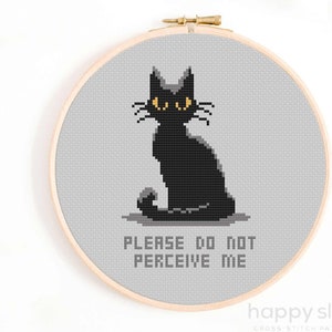 May include: Cross stitch pattern featuring a black cat with yellow eyes sitting on a grey background. The text "PLEASE DO NOT PERCEIVE ME" is below the cat.
