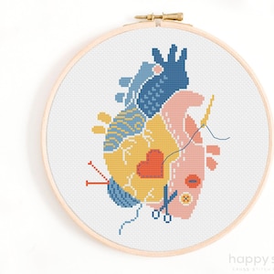 May include: A cross stitch pattern of a heart made up of different shapes and colours, including yellow, blue, pink, and red. The heart is surrounded by sewing supplies, including scissors, thread, and a needle.
