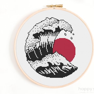 May include: Black and white cross stitch pattern of a large wave with a red sun behind it. The wave is stylised and has a traditional Japanese design.