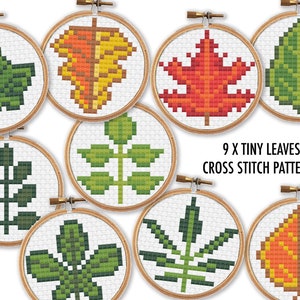May include: Nine cross stitch patterns featuring tiny leaves in various colors, including green, red, orange, and yellow. The patterns are displayed in embroidery hoops.
