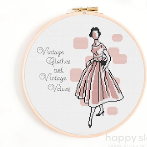 May include: Cross stitch pattern featuring a woman in a pink dress with the text "Vintage Clothes not Vintage Values".