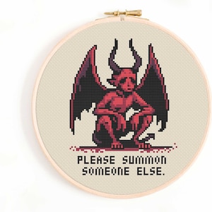 May include: Cross-stitch pattern featuring a red demon with wings and the text "Please summon someone else."