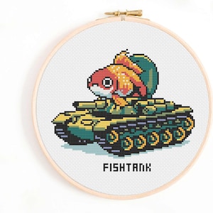 May include: Cross-stitch embroidery of a goldfish riding a tank, in shades of red, orange, green, and yellow. The word "FISHTANK" is stitched below the tank. The embroidery is set in a wooden hoop.