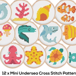May include: Twelve mini cross stitch patterns featuring underwater sea life, including a dolphin, coral, seashell, clownfish, jellyfish, eel, shark, angelfish, octopus, starfish, turtle, and a submarine.