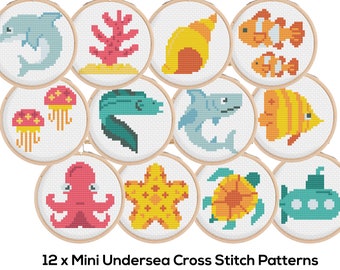 May include: Twelve mini cross stitch patterns featuring underwater sea life, including a dolphin, coral, seashell, clownfish, jellyfish, eel, shark, angelfish, octopus, starfish, turtle, and a submarine.