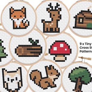 Peut inclure: Neuf petits motifs de point de croix sur le thème de la forêt, présentés dans des cerceaux en bois. Les motifs incluent un renard, un cerf, une cabane, un arbre, une bûche, un champignon, un hibou, un écureuil et un autre arbre. Le texte "9 x Tiny Forest Cross Stitch Patterns" est également visible.