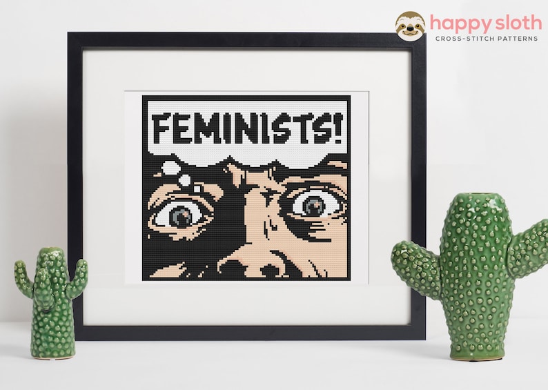 a cross stitch picture of a face with the words feminist on it