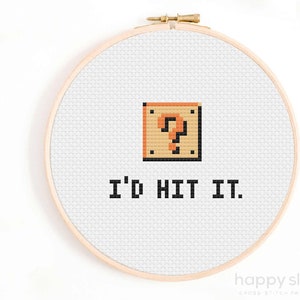 May include: A white embroidery hoop with a pixelated image of a question mark block from the Super Mario Bros. video game. The text "I'd hit it." is below the image.