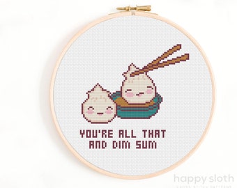 May include: Cross stitch pattern featuring two cartoon dim sum dumplings with chopsticks and the text "You're all that and dim sum".