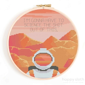 May include: Cross stitch pattern featuring an astronaut in a white spacesuit standing on a red and orange planet with the text "I'M GONNA HAVE TO SCIENCE THE SHIT OUT OF THIS."