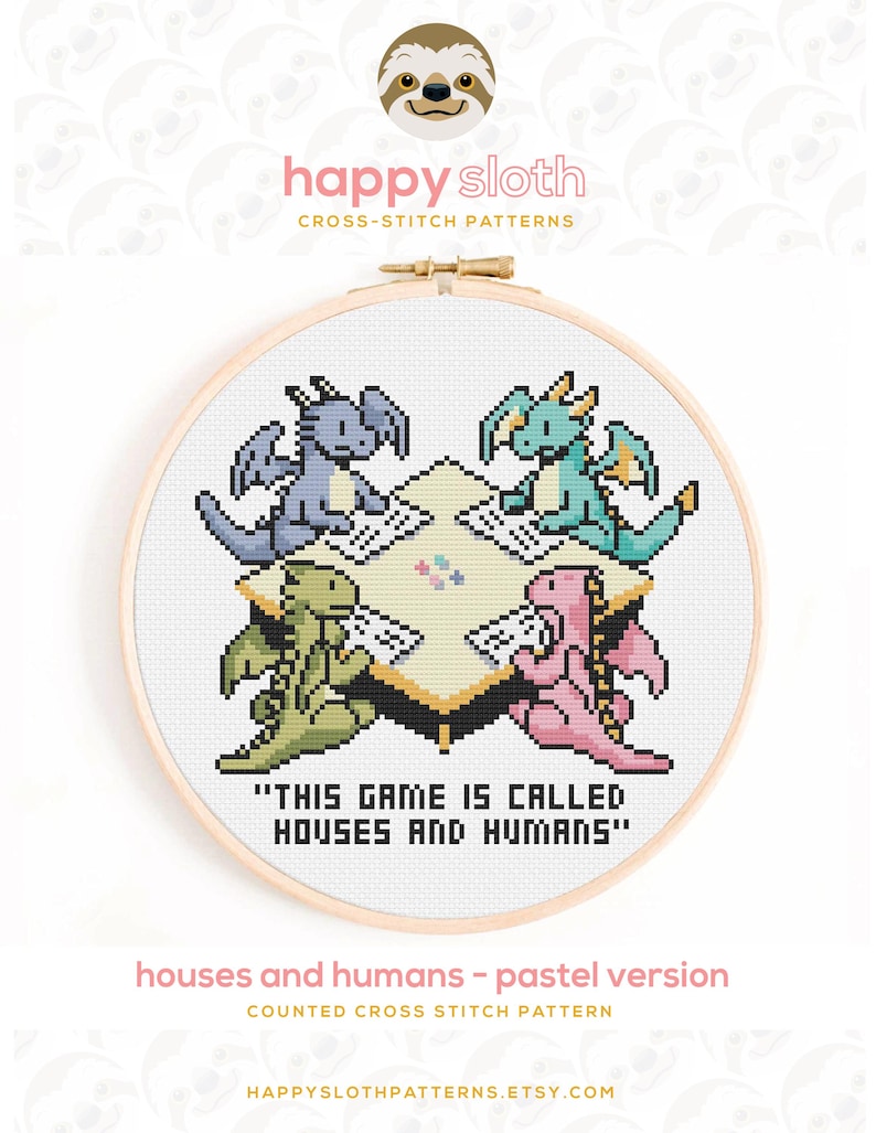 May include: A cross-stitch design in a wooden hoop, depicting four dragons in pastel shades playing a game. The text reads "THIS GAME IS CALLED HOUSES AND HUMANS". The design is labelled "houses and humans - pastel version".