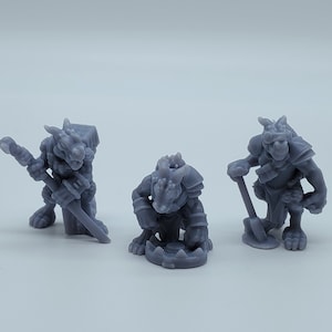 May include: Three gray plastic figurines of lizard-like creatures. One is holding a sword, another is holding a pickaxe, and the third is holding a shield.