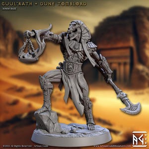 May include: A gray miniature figure of a skeletal pharaoh, holding a scale and a curved blade. The figure is posed on a rocky base, with the text "GUUL'RATH + DUNE TOMBLORD" above. The base is 30mm.
