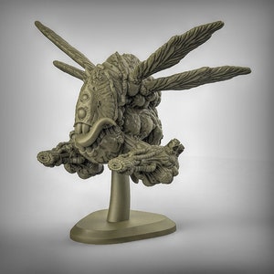 May include: A 3D printed model of a creature with a textured, organic appearance. It has multiple eyes, a large mouth with teeth, and wings. The creature is mounted on a small, round base.