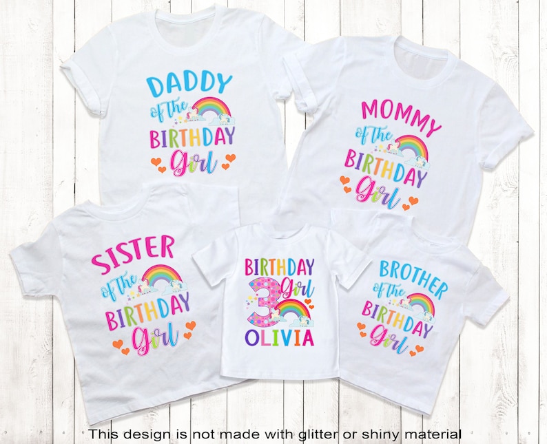 May include: Set of five white t-shirts with rainbow and unicorn designs. The shirts say "Daddy of the Birthday Girl", "Mommy of the Birthday Girl", "Sister of the Birthday Girl", "Birthday Girl" with the number 3 and the name Olivia, and "Brother of the Birthday Girl".
