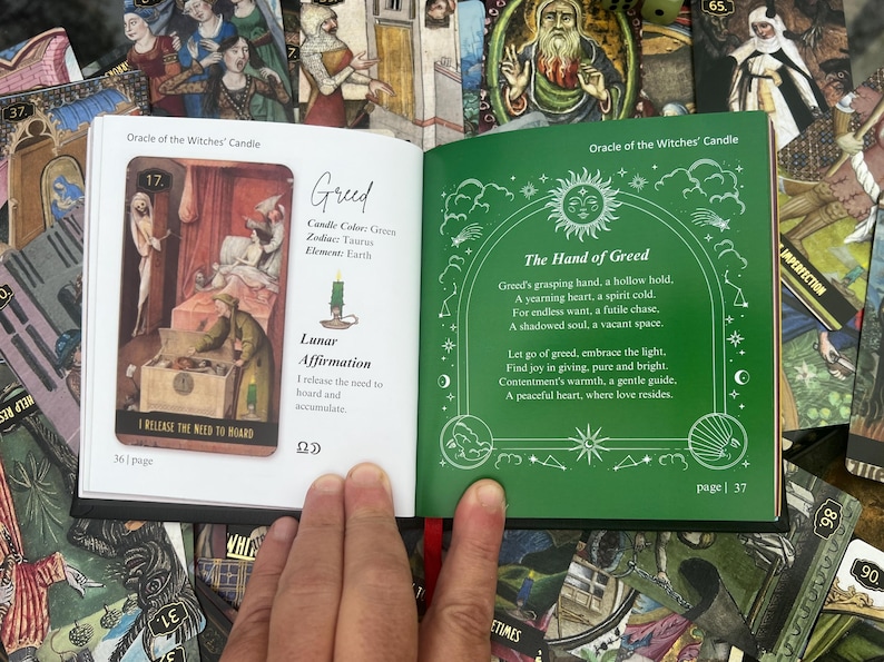 May include: An open book from the "Oracle of the Witches' Candle" deck, featuring a card with an illustration of a scene with figures and text. The opposite page has green text on a green background. The book is surrounded by other tarot cards.