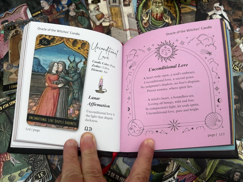 May include: An open book displaying a tarot card reading. The left page features a card with an illustration of two figures embracing and a horned creature. The right page has text about unconditional love, with a pink background.