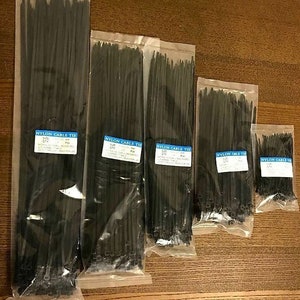 May include: Five packages of black nylon cable ties in various sizes. The packages are labeled with the text "Nylon Cable Tie" and the size of the ties.