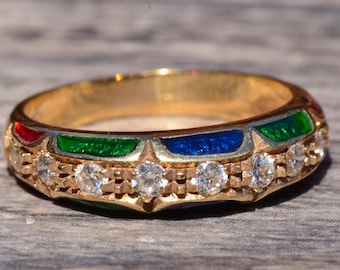 May include: A gold band ring with a row of small diamonds and a colorful enamel design. The enamel is green, blue, and red.