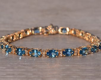 Blue Topaz and Natural Diamond Bracelet in Yellow Gold