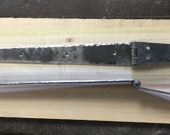 May include: Two long, silver-colored metal strap hinges with a hammered texture. Each hinge features a central pivot point and circular ends with pre-drilled holes for mounting. The hinges are displayed in both a flat, top-down view and a side profile.