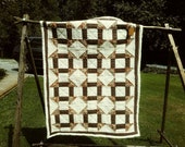Brown churn-dash quilt