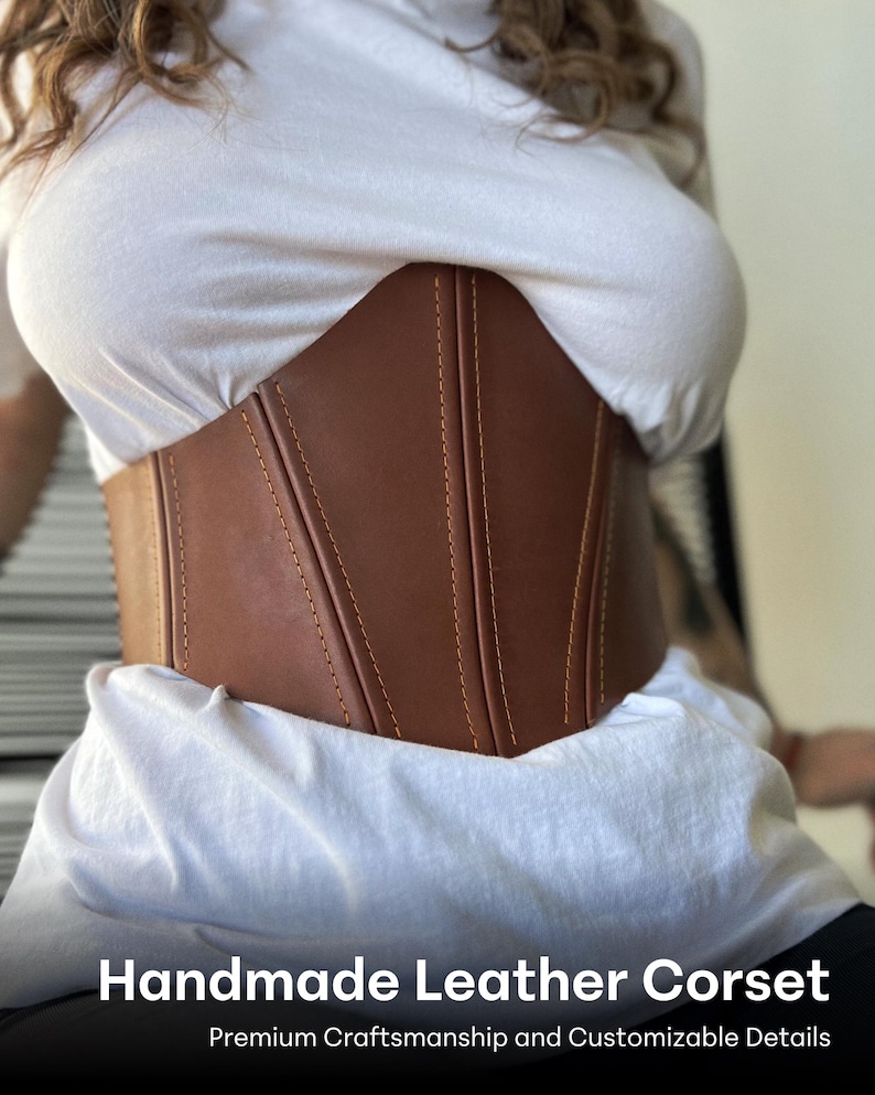 May include: A handmade brown leather corset with visible stitching. The corset is worn over a white shirt. The text "Handmade Leather Corset" and "Premium Craftsmanship and Customizable Details" are displayed at the bottom of the image.