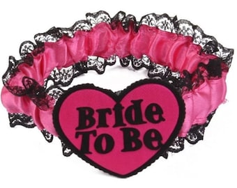 Deluxe Pink And Black Bride To Be Garter, Ideal Accessory For Hen And Bachelorette Parties. Heart Shaped Design, Finished With Black Lace.