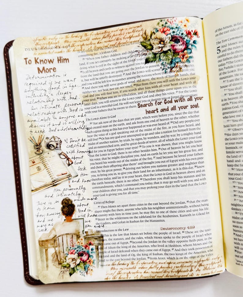 May include: A close-up of a page from a Bible with handwritten notes and colorful illustrations. The text on the page includes the words "To Know Him More" and "Search for God with all your heart and all your soul."
