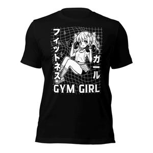 May include: Black t-shirt featuring a white graphic of an anime girl lifting weights. The graphic includes the text "GYM GIRL" and Japanese characters.