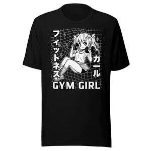 May include: Black t-shirt with a white graphic of a cartoon girl lifting weights. The text "Gym Girl" is below the image. The text "フィットネス" and "ガール" is on the left and right side of the image.