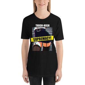 May include: Black t-shirt with a graphic of a woman in a short skirt and thigh-high stockings. The graphic has a glitch effect and a yellow banner across the bottom that says "THIGH-HIGH SUPREMACY!"