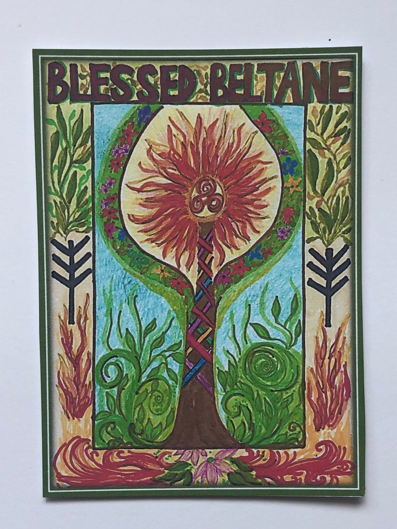 May include: A green framed illustration of a tree with a red sun-like top and a brown trunk. The tree is surrounded by green leaves and flowers. The text "Blessed Beltane" is at the top of the image.
